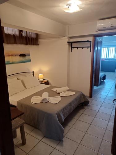a bedroom with a bed with two towels on it at Voulias Αpartments in Kinion
