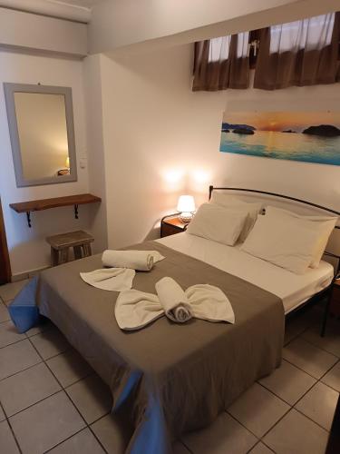a bedroom with a bed with two towels on it at Voulias Αpartments in Kinion