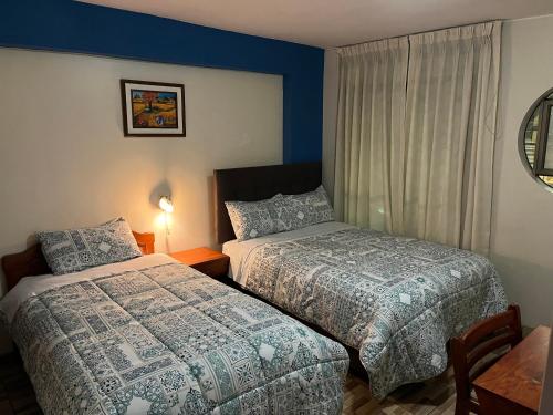 En eller flere senge i et værelse på Hostal Inkanto Taruma