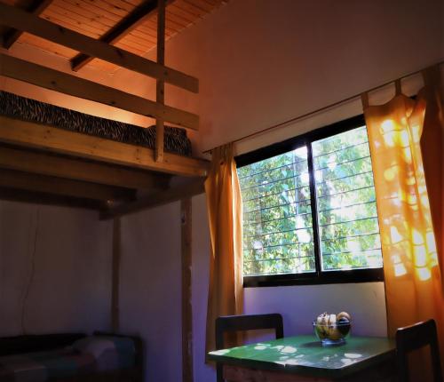 a room with a bunk bed and a table and a window at Colibrí Apart in El Soberbio