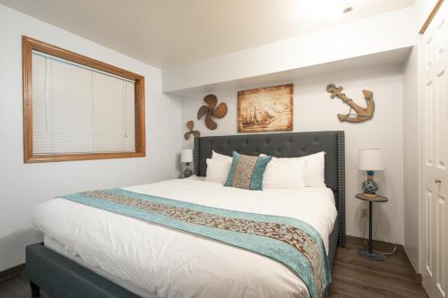 a bedroom with a large white bed with a window at Aurora at Nautilus - Pet Friendly Oceanfront Condo in Ocean Shores