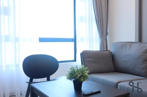 a living room with a couch and a chair at Homesuite' Home at Jesselton Quay in Kota Kinabalu