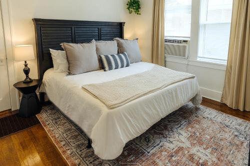 a bedroom with a large white bed with pillows at Historic Revival King Bed Midtown Memphis 66 Fast WiFi Free Parking Yes Pets in Memphis