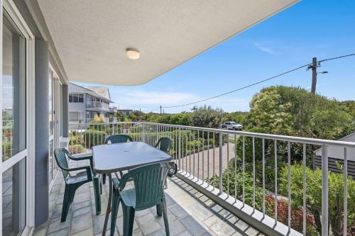 a patio with a table and chairs on a balcony at 2 Ocean Shores in Peregian Beach