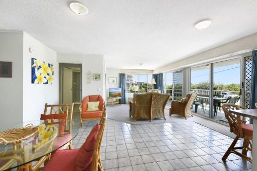 a living room with a table and chairs at 2 Ocean Shores in Peregian Beach