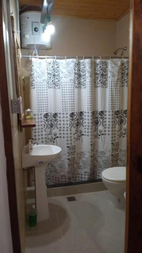a bathroom with a sink and a shower curtain at Lo de La Abuela 1 in Goya