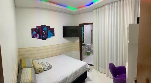 a bedroom with a bed and a tv on the ceiling at Mansão Digital in Brasilia