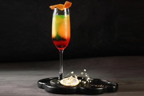 a drink on a black coaster with an orange slice at JM Marvel Hotel & Spa in Hanoi