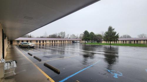 an empty parking lot in front of a building at Super 8 by Wyndham Centerville-Richmond in Centerville