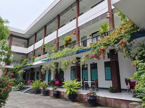 a building with plants on the side of it at Thuy Loi Hotel in Hoi An
