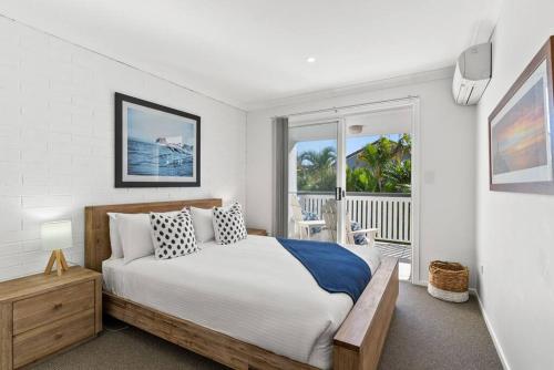 1 dormitorio con 1 cama y balcón en Fuller Holidays - Somerset@Byron en Byron Bay