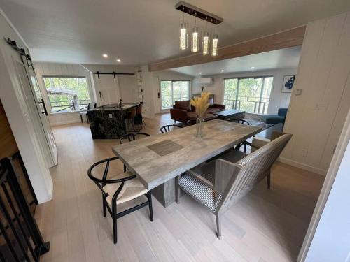 a dining table and chairs in a living room at The River House in Grants Pass