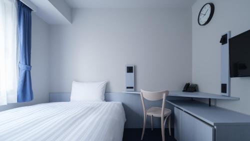 a bedroom with a bed and a desk and a chair at Toyoko Inn Tokyo Haneda Airport No.2 in Tokyo