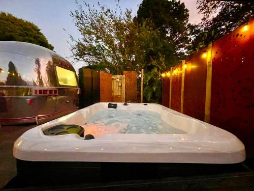 a bath tub sitting next to a rv and a trailer at Frankie the Silver Bullet Airstream in Katoomba