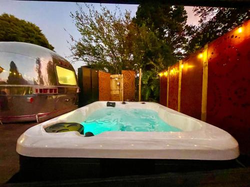 a jacuzzi tub in a backyard with a rv at Frankie the Silver Bullet Airstream in Katoomba