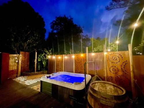 a jacuzzi tub in a backyard at night at Frankie the Silver Bullet Airstream in Katoomba