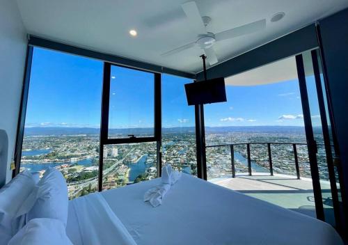 a room with a bed with a view of a city at Broadbeach luxury Casino riverview skyline 2bedroom apt 48F in Gold Coast