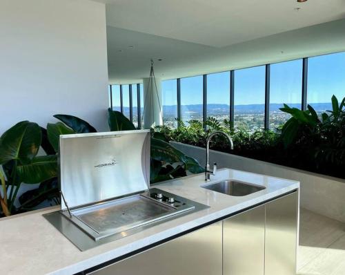 a kitchen with a sink and some plants at Broadbeach luxury Casino riverview skyline 2bedroom apt 48F in Gold Coast