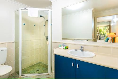 a bathroom with a sink and a shower at Oasis 8 at Palm Cove in Palm Cove
