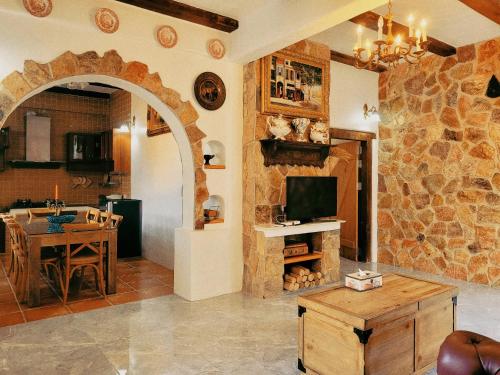 a kitchen and dining room with a stone wall at Swiss Hotel Pattaya in Sattahip