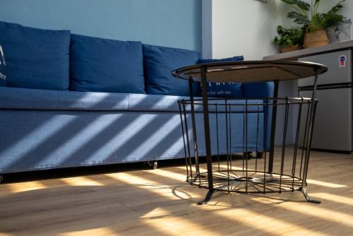 a table in front of a blue couch at Sleepier Multi-Minsu Tainan in Tainan