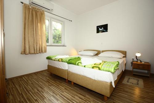 Postel nebo postele na pokoji v ubytování Apartments Vesna