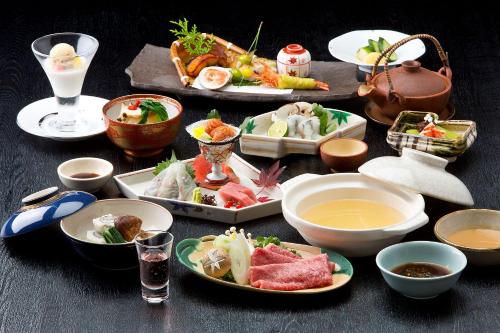 a table with plates of food and bowls of food at Kinzan in Kobe