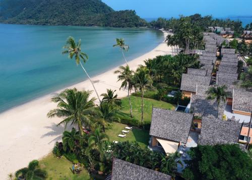 an aerial view of a beach with houses and palm trees at Utalay Koh Chang Villas in Ko Chang