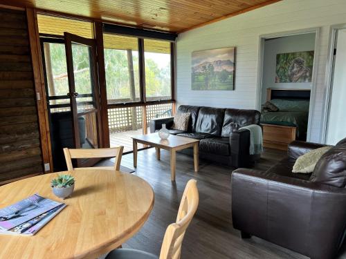 a living room with a couch and a table at Happy Wanderer Holiday Resort The Grampians in Wartook