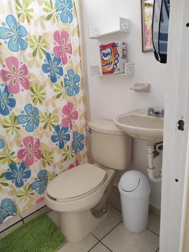 a bathroom with a toilet and a sink at Tu casa en Mazatlan. in Mazatlán