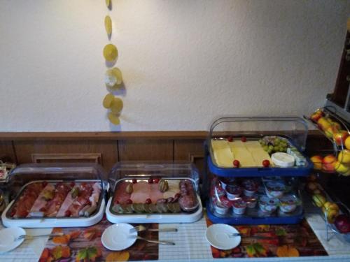 three trays of food sitting on top of a table at Pension Schulze in Oranienbaum-Wörlitz