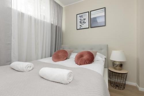 two white beds with pillows on them in a bedroom at Cute & Cozy Apartment Grochowska by Renters in Warsaw