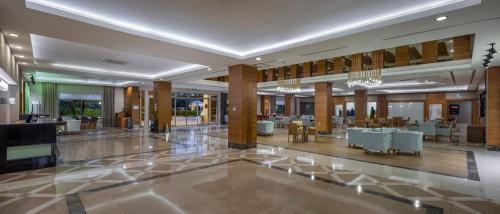 a lobby of a hotel with tables and chairs at Wyndham Garden Lara in Lara
