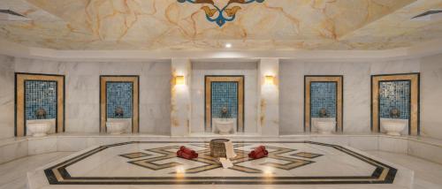 a large room with a ceiling with a painting on it at Wyndham Garden Lara in Lara