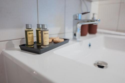 two bottles of essential oils sitting on a bathroom sink at Südstrand, Zentral, Balkon, Wifi, Fahrstuhl, Parken in Wilhelmshaven