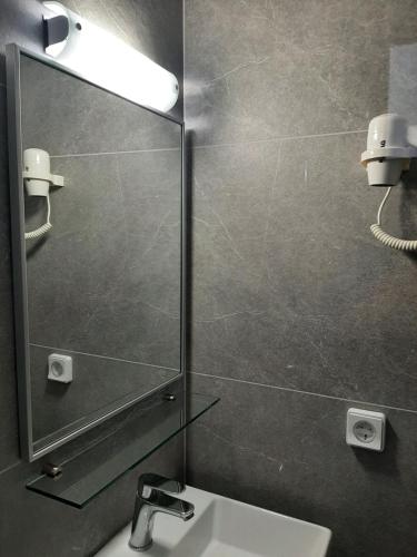 a bathroom with a mirror and a sink at Ostria in Agia Galini