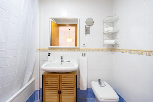 a bathroom with a sink and a mirror and a toilet at 148 Paradise Sunny Home By Sunkeyrents in Adeje