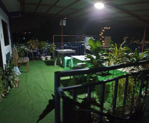 a patio with a lot of plants and tables at Marbeth Inn in Coron