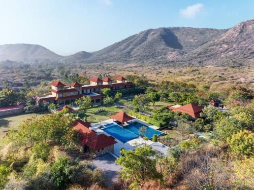 an aerial view of the resort with mountains in the background at Anandam - A Luxury Resort in Udaipur in Udaipur