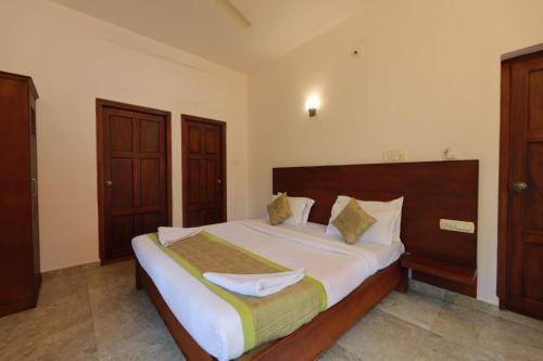 a bedroom with a large bed in a room at Green Shades in Munnar