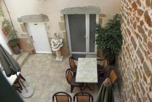 a view of a room with a table and chairs at L’Ostalou in Issoire