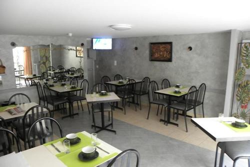 a dining room with tables and chairs in a restaurant at L’Ostalou in Issoire