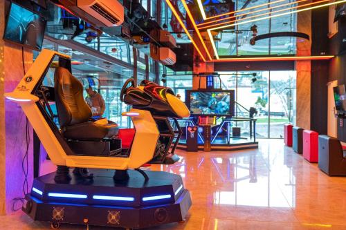 a video game room with a yellow chair in a store at Aquapark Health Resort & Medical SPA Panorama Morska All Inclusive in Jarosławiec