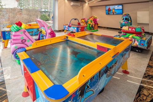 a pool in a room with several play equipment at Aquapark Health Resort & Medical SPA Panorama Morska All Inclusive in Jarosławiec