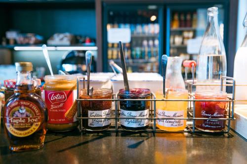 a group of different types of condiments on a counter at ibis Saint Malo Plage in Saint Malo