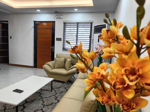 a living room with a couch and a table and flowers at Aurora Villas and Cabin Resort in Clark