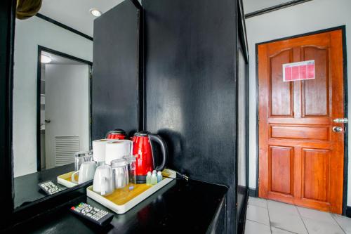 a kitchen with a counter with a red appliance on it at Happy Jomtien - Direct Beach Access, Sea View & Central Location in Jomtien Beach