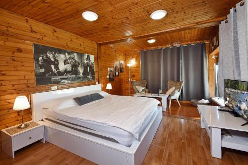 a bedroom with a large white bed and a desk at Biktot Nofim in Manot