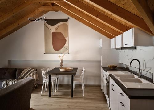 a kitchen and living room with a table and a couch at Giannoulis City Apartments in Zakynthos Town