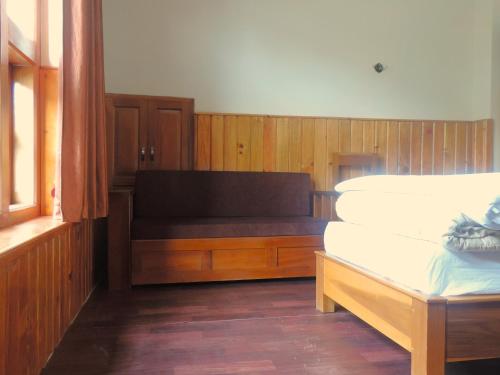 Ένα ή περισσότερα κρεβάτια σε δωμάτιο στο Kharjap Homestay